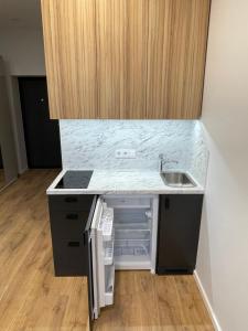 a kitchen with a sink and a counter top at Airport Apartment 22 Self Check-In in Vilnius