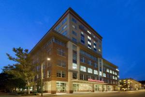 a tall building with a sign on the side of it at Hilton Garden Inn Ithaca in Ithaca