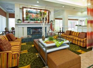 a living room with two couches and a fireplace at Hilton Garden Inn Jackson/Pearl in Pearl