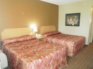 a hotel room with two beds and a telephone at Bayview Inn Orillia in Orillia