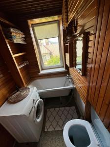 a small bathroom with a toilet and a window at Przestronny apartament na wyłączność w centrum miasta - Mszana M11 in Mszana Dolna