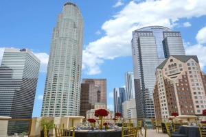 a view of a city skyline with tables and chairs at Hilton Checkers Los Angeles in Los Angeles