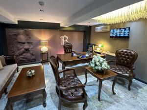 a living room with a couch and a table and chairs at THE ROYALS HOTEL in İzmir