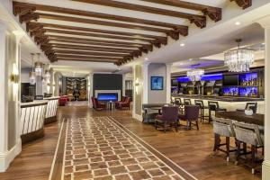 a lobby of a hotel with a bar at Hilton Checkers Los Angeles in Los Angeles