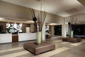a lobby with a vase with branches in it at DoubleTree by Hilton Monrovia - Pasadena Area in Monrovia