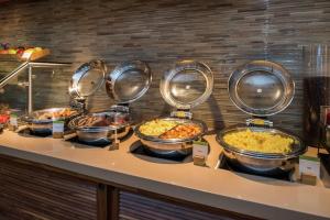 a bunch of food in bowls on a counter at DoubleTree by Hilton LAX - El Segundo in El Segundo