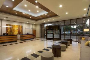 a lobby with couches and tables in a building at DoubleTree by Hilton Los Angeles Norwalk in Norwalk