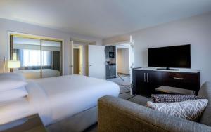 a hotel room with a large bed and a tv at DoubleTree by Hilton Los Angeles Norwalk in Norwalk
