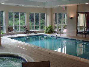 a large swimming pool in a hotel with windows at Hilton Garden Inn Lexington Georgetown in Georgetown