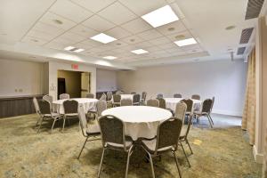 a room with tables and chairs in a room at Hilton Garden Inn Ridgefield Park in Ridgefield Park +19 photos