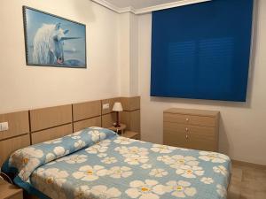 a bedroom with a bed with a picture of a horse at APARTAMENTO EN MARINA DOR (OROPESA) in Oropesa del Mar +19 photos