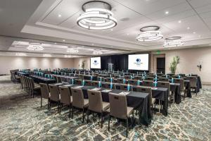 a conference room with tables and chairs and a screen at DoubleTree by Hilton Carson in Carson +57 photos
