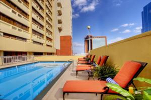 a row of chairs sitting next to a swimming pool at DoubleTree by Hilton Little Rock in Little Rock