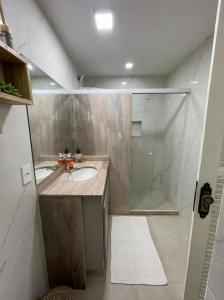 a bathroom with a sink and a shower at Hotel Pousada Recanto das Árvores in Búzios