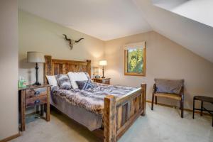 a bedroom with a bed and a table and a chair at Hidden Hollow in Bozeman