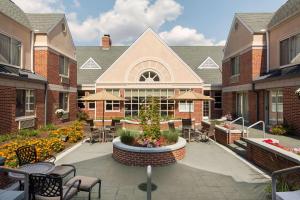 a courtyard with chairs and tables and a building at Hilton Garden Inn Lancaster in Lancaster