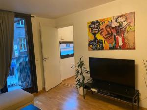 a living room with a large flat screen tv at Leilighet midt i Oslo sentrum 2 soverom og stue in Oslo