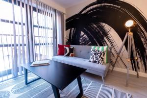 a living room with a blue couch and a large window at Pristine 1 and 2 bedroom apartments near business district by Belvilla in Birmingham