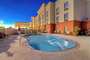 a swimming pool in front of a hotel at Hampton Inn Midland in Midland