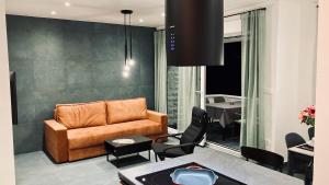 a living room with a couch and a table at Apartment Tomic Krk in Krk