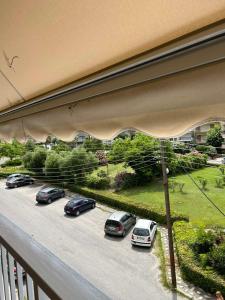 a balcony with cars parked in a parking lot at Jenny's Coastal escape in Nea Kallikrateia