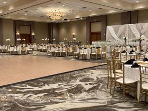 un salón de banquetes con mesas y sillas en una habitación en DoubleTree by Hilton Bay City - Riverfront, en Bay City