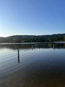 a large lake with a dock in the water at Les hortensias de Stéfanick in Mûr-de-Bretagne