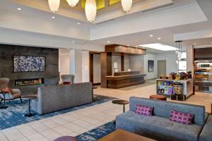 a lobby of a hotel with a couch and chairs at Hilton Garden Inn Kansas City/Kansas in Kansas City