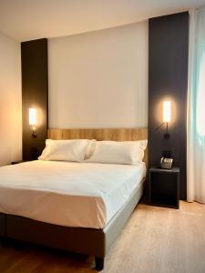 Postel nebo postele na pokoji v ubytování Hotel Leonessa