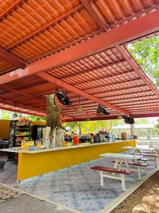 a restaurant with a counter with tables and benches at R Las chulas in Puerto Morelos