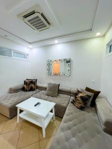 a living room with a couch and a table at Rif Appartment in Al Hoceïma