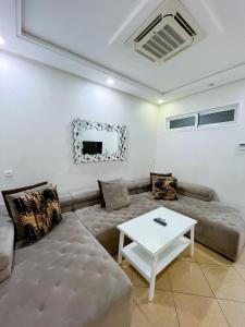 a living room with a couch and a table at Rif Appartment in Al Hoceïma