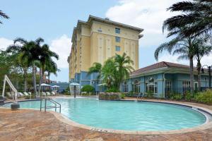 a large swimming pool in front of a building at Hilton Garden Inn Orlando Lake Buena Vista in Orlando