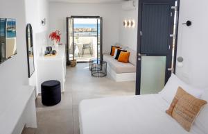 a bedroom with a bed and a living room at Anafi Drops Mare in Anafi