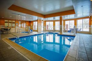 - une grande piscine d'eau bleue dans un bâtiment dans l'établissement Hilton Garden Inn Kankakee, à Kankakee