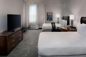 a hotel room with two beds and a flat screen tv at DoubleTree by Hilton Memphis Downtown in Memphis