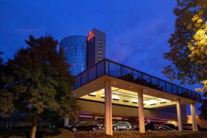 a building with cars parked in a parking lot at Hilton Memphis in Memphis