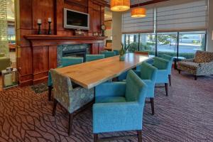 uma sala de jantar com uma mesa de madeira e cadeiras azuis em Hilton Garden Inn Memphis/Southaven em Southhaven