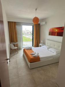 um quarto com uma cama e uma grande janela em Casa Leukos Salento - con terrazza privata em Vignacastrisi