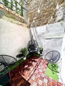an outdoor patio with two chairs and a table at NapoliOn - Luxury Apartment in Naples