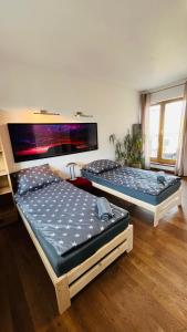 two beds are sitting in a room at Warszawa Bemowo Pokoje in Warsaw