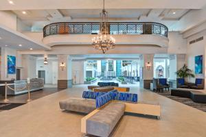 a hotel lobby with couches and a chandelier at Embassy Suites by Hilton Miami International Airport in Miami +74 photos