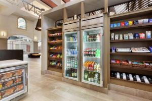 a store with a refrigerator filled with lots of food at Embassy Suites by Hilton Milpitas Silicon Valley in Milpitas