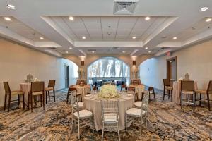 米尔皮塔斯Embassy Suites by Hilton Milpitas Silicon Valley的有桌椅和大窗户的宴会厅 更多37张照片