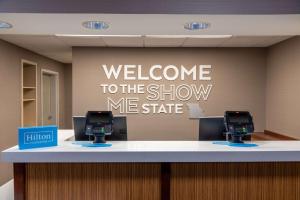 a welcome to the show me state sign in a waiting room at Hampton Inn Kansas City-Lee's Summit in Lees Summit