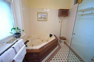 a bathroom with a bath tub and a toilet at Kilmany Park Estate in Sale