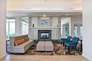 a living room with a couch and a fireplace at Hilton Garden Inn Mobile East Bay / Daphne in Daphne