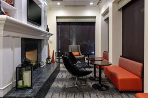 a waiting room with chairs and a fireplace at Hilton Garden Inn Mobile West I-65 Airport Boulevard in Mobile