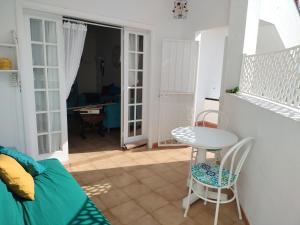 a small living room with a table and chairs at Tenerife Sweet Home, Cheap and Clean, Pool, Beach, WiFi, Quite in Los Cristianos