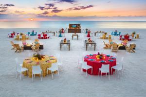 a restaurant on the beach with tables and chairs at Hilton Marco Island Beach Resort and Spa in Marco Island +37 photos